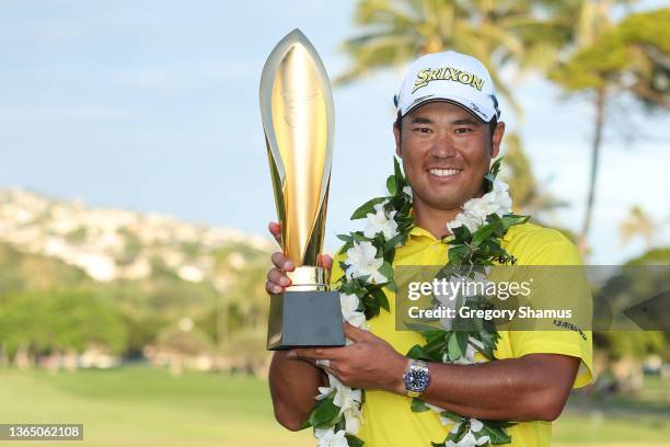 Hideki Matsuyama of Japan celebrates with the trophy after winning in a one-hole playoff against Russell Henley of the United States during the final...