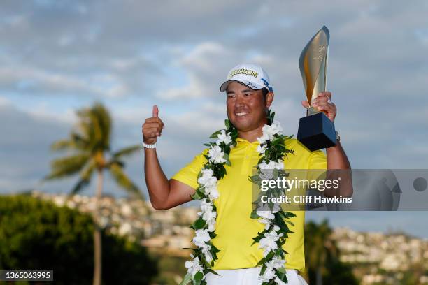 Hideki Matsuyama of Japan celebrates with the trophy after winning in a one-hole playoff against Russell Henley of the United States during the final...