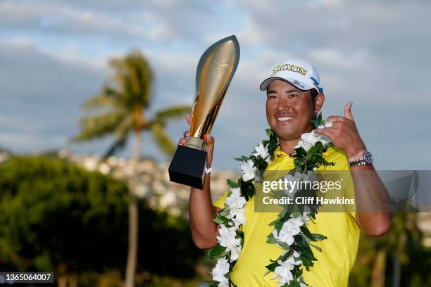 Hideki Matsuyama of Japan celebrates with the trophy after winning in a one-hole playoff against Russell Henley of the United States during the final...