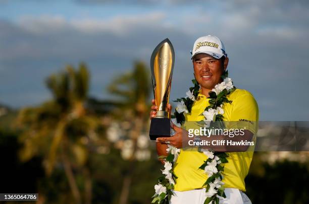 Hideki Matsuyama of Japan celebrates with the trophy after winning in a one-hole playoff against Russell Henley of the United States during the final...