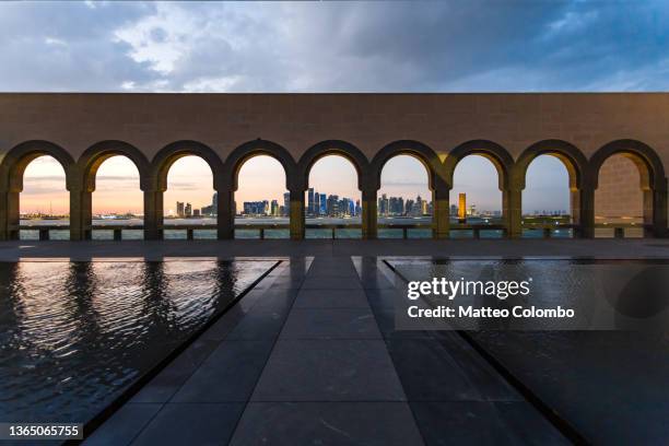 arches and city of doha, qatar - middle east stock pictures, royalty-free photos & images