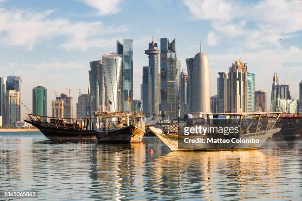 doha skyline and fishing boats, qatar - qatar stock pictures, royalty-free photos & images