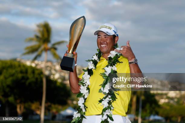 Hideki Matsuyama of Japan celebrates with the trophy after winning in a one-hole playoff against Russell Henley of the United States during the final...