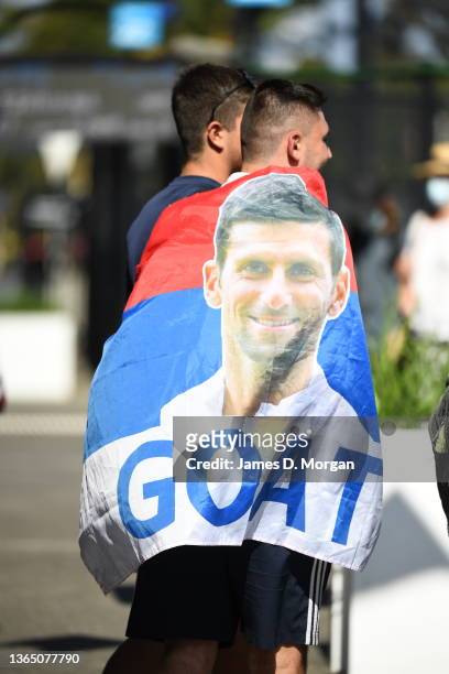 Fan wears a Serbian flag with Novak Djokovic on it during day one of the 2022 Australian Open at Melbourne Park on January 17, 2022 in Melbourne,...