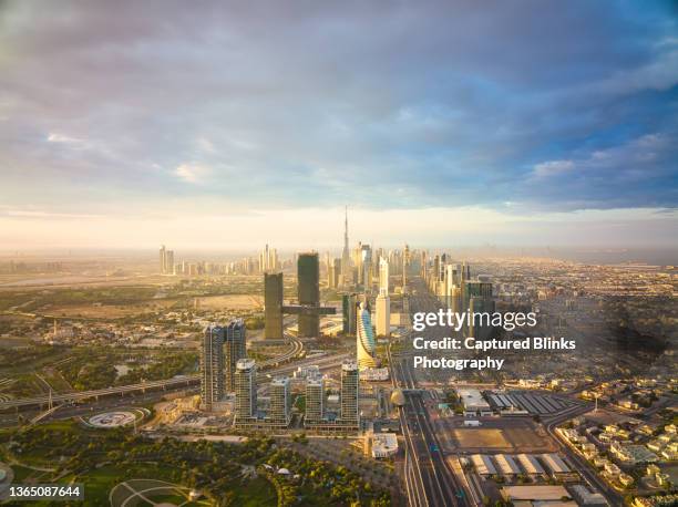 sunrise aerial view of dubai city skyline - exhibition center stock-fotos und bilder