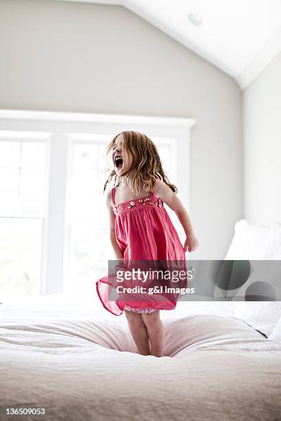 daughter jumping and screaming on bed - tantrum stock pictures, royalty-free photos & images