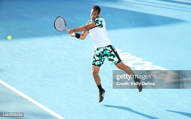 Salvatore Caruso of Italy plays a backhand in his first round singles match against SMiomir Kecmanovic of Serbia uring day one of the 2022 Australian...