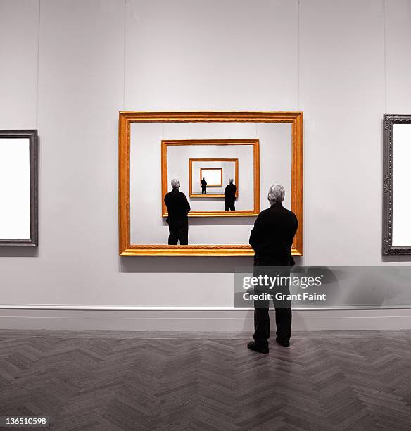 man looking into framed image. - gallery imagens e fotografias de stock