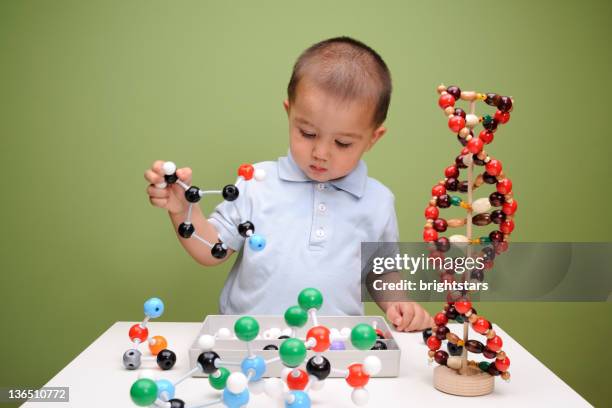 boy building molecular structures - genetics stock pictures, royalty-free photos & images