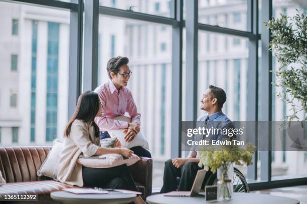 operaio bianco indiano in sedia a rotelle discussione nella sala dell'ufficio con il suo collega - asian male smiling foto e immagini stock