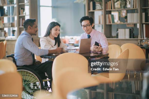 indian businessman in wheelchair leading group discussion in cafe - meeting preparation stock pictures, royalty-free photos & images