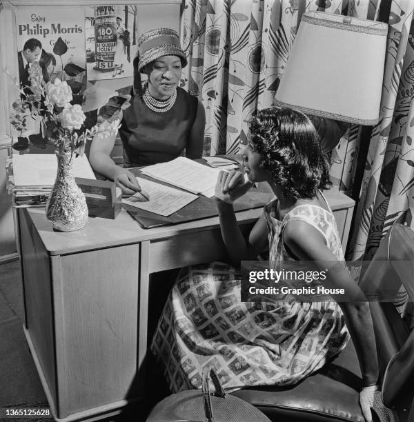 Model Lillie Jones attends an interview at an office in Chicago, USA, 1957. The interviewer is Bettye Everett-Lightsy a former model, who founded...