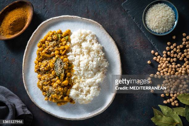spicy masala chickpea with basmati rice indian vegan plant based - masala stock pictures, royalty-free photos & images