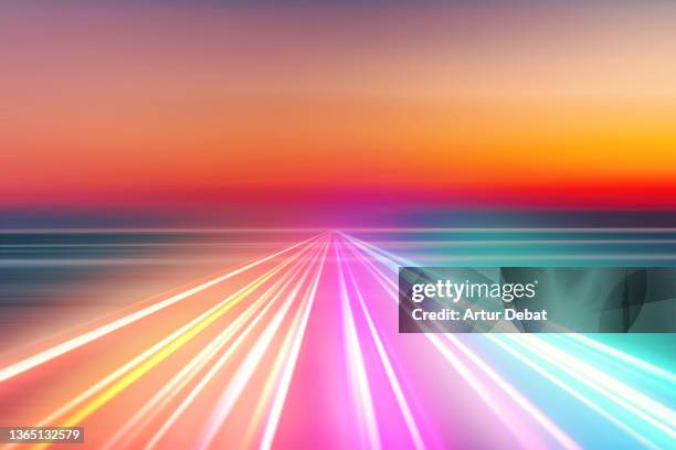 abstract picture of colorful light trails crossing twilight sky with fast motion. - multi coloured light stock pictures, royalty-free photos & images