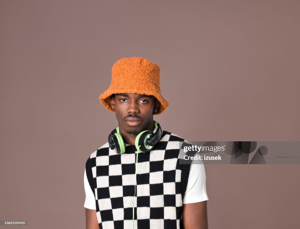 Confident young man against brown background