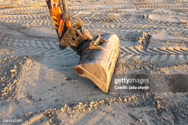 shovel bucket in the sand - shovel stockfoto's en -beelden