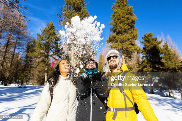 happy diverse young friends having fun together while playing with the snow on a winter day - bola de neve imagens e fotografias de stock