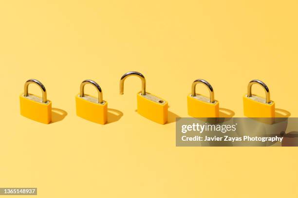 five yellow padlocks on yellow background - lock fotografías e imágenes de stock