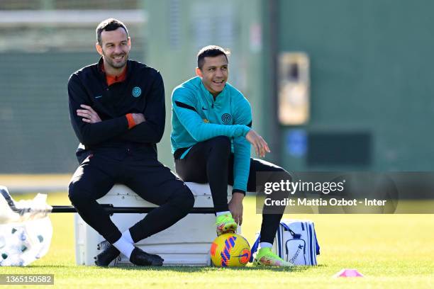 Samir Handanovic of FC Internazionale and Alexis Sanchez of FC Internazionale smile during the FC Internazionale training session at the club's...