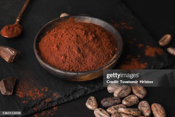 cocoa powder in a wooden bowl. - chocolate powder stockfoto's en -beelden