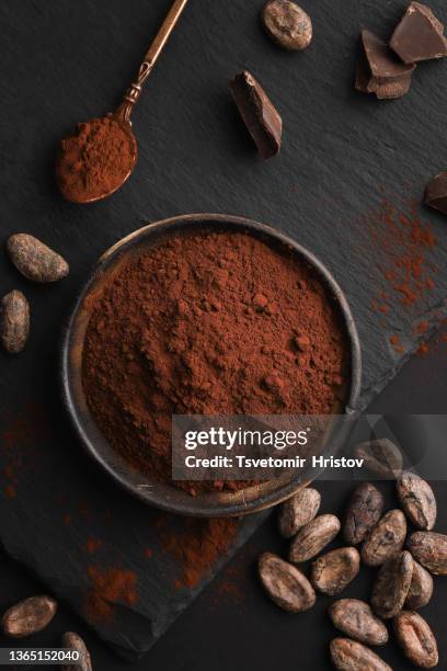 cocoa powder in a wooden bowl.  top view. flat lay. - cacau imagens e fotografias de stock