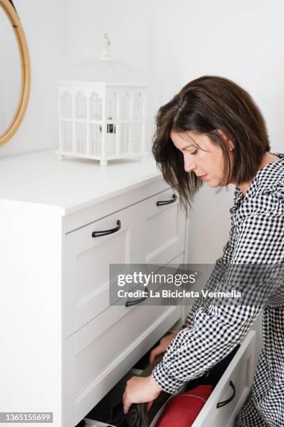 woman organizing drawers - entrümpeln stock-fotos und bilder