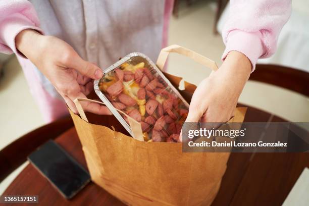 crop woman unpacking takeaway junk food - bag of chips stock pictures, royalty-free photos & images