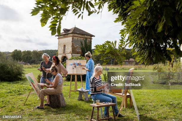 painting with a picturesque view - female friendship painting stock pictures, royalty-free photos & images