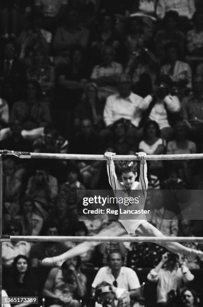 Romanian gymnast Nadia Comaneci wins a gold medal on the uneven bars at the 1976 Summer Olympics in Montreal, Canada, 26th July 1976.