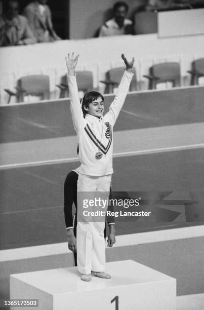Romanian gymnast Nadia Comaneci wins a gold medal for the balance beam at the 1976 Summer Olympics in Montreal, Canada, 26th July 1976.