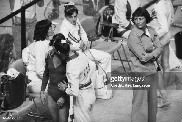 Gymnasts embrace each other after the balance beam at the 1976 Summer Olympics in Montreal, Canada, 26th July 1976. Romanian gymnast Nadia Comaneci...