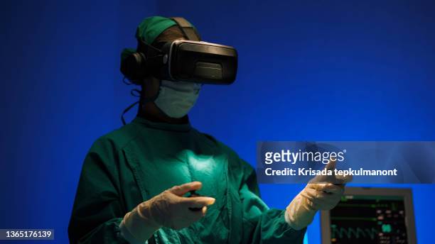 doctors in vr glasses performing surgery in hospital. - virtual reality medical stock pictures, royalty-free photos & images