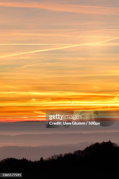 condensation trails,scenic view of dramatic sky during sunset,rubacker,deggenhausertal,germany - sunset with jet contrails stock pictures, royalty-free photos & images