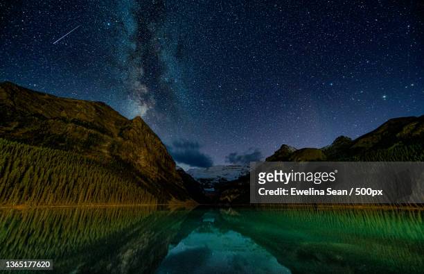 scenic view of lake against sky at night,lake louise,alberta,canada - lake louise ストックフォトと画像