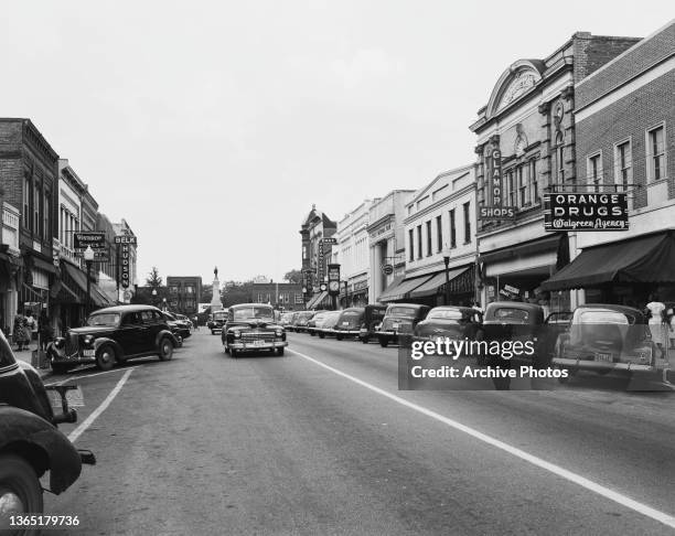 Shops on Russell Street in Orangeburg, South Carolina, USA, circa 1954. The statue of a Confederate soldier stands at the end of the street.