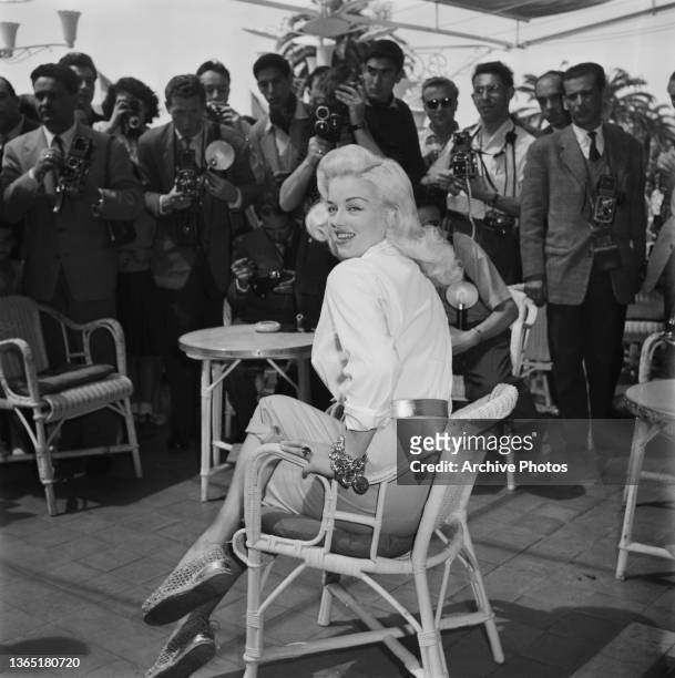 English actress Diana Dors poses for photographers at the 9th Cannes Film Festival in Cannes, France, May 1956.