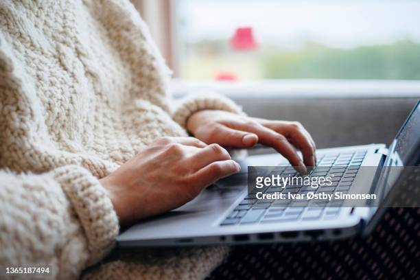 closeup of a woman typing on a laptop computer keyboard, working from home - student journalist stock pictures, royalty-free photos & images
