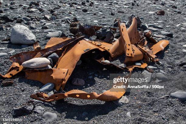 rusted scrap metal on rocky beach,iceland - landslag stock pictures, royalty-free photos & images