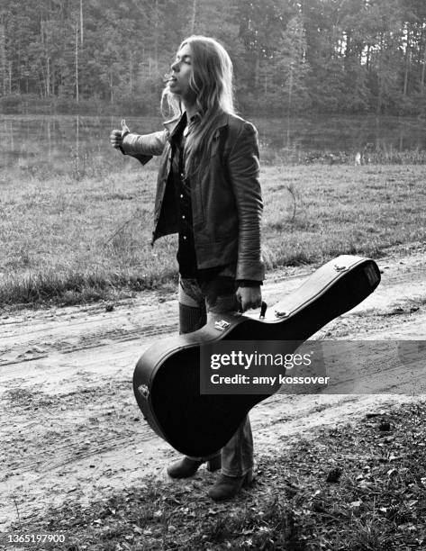 Gregg Allman pretends to hitchhike during a photo shoot in 1974. Photos were shot at the Allman Brothers farm known as Idlewild South and were used...