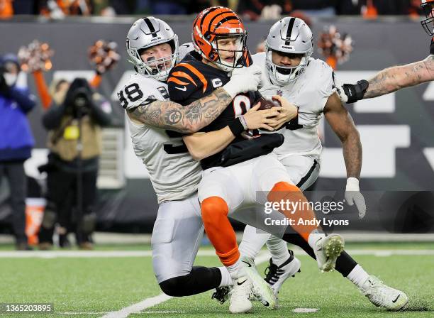 Defensive ends Maxx Crosby and Yannick Ngakoue of the Las Vegas Raiders sack quarterback Joe Burrow of the Cincinnati Bengals during the third...