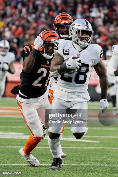 Cornerback Mike Hilton of the Cincinnati Bengals chases after running back Josh Jacobs of the Las Vegas Raiders during the first half of the AFC Wild...