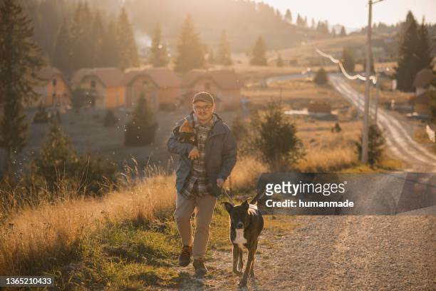 young caucasian man walking his dog in nature - prairie dog 個照片及圖片檔