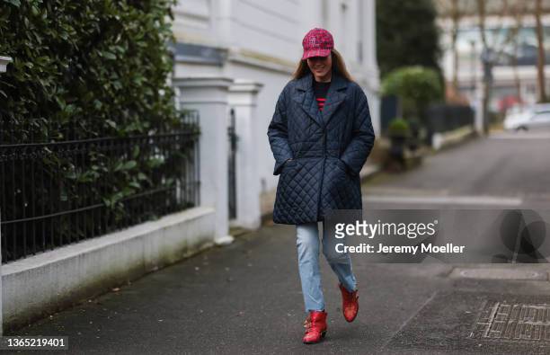Yasmin von Schlieffen-Nannen wearing navy blue Ganni jacket, blue Mother jeans, red Chloe boots, black and red striped Zara sweater and red Saint...