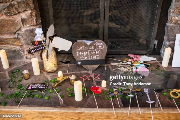 wedding selfie props laid out on hearth for guests - hashtag ストックフォトと画像