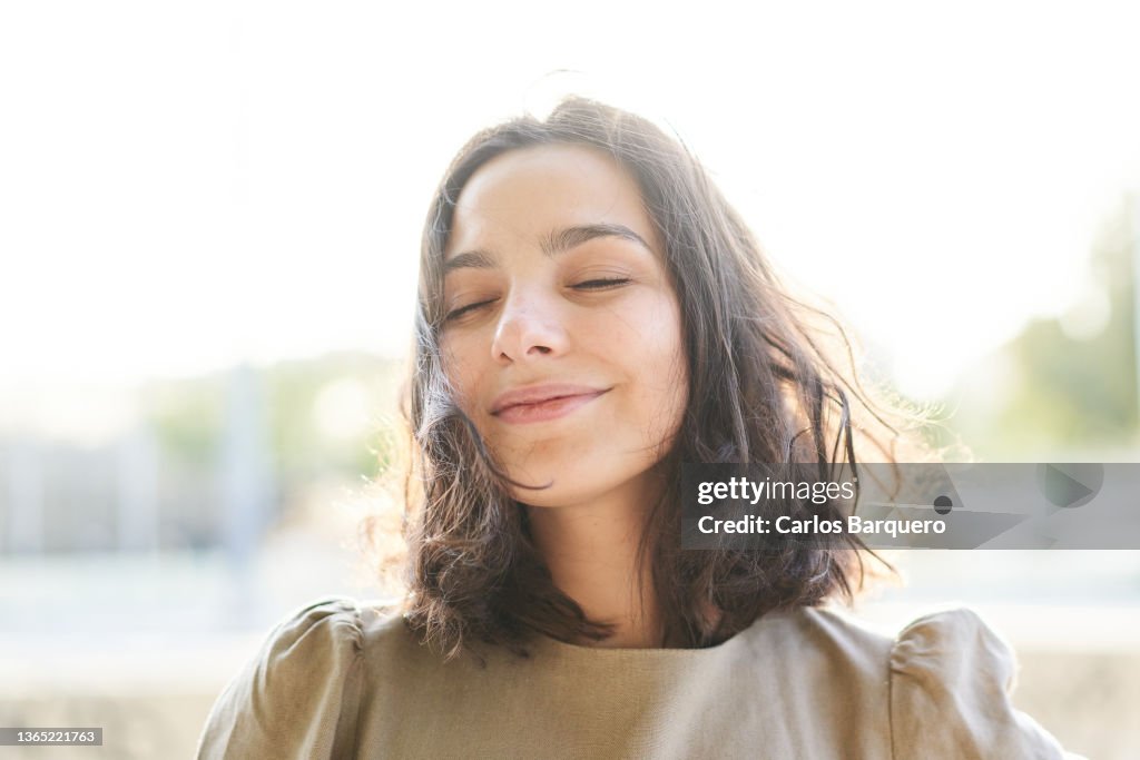 Portrait of a Caucasian serene woman enjoying the freedom.