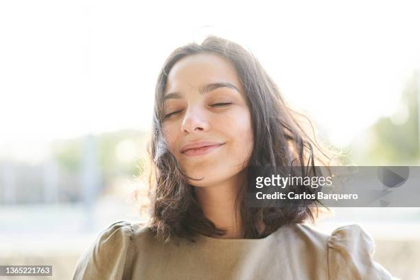 portrait of a caucasian serene woman enjoying the freedom. - zen stock pictures, royalty-free photos & images