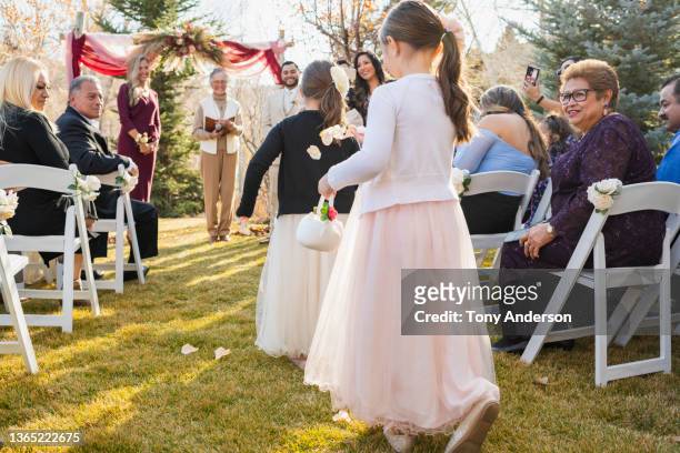 flower girls throwing petals as wedding guests look on - 70s wedding black couple stock pictures, royalty-free photos & images