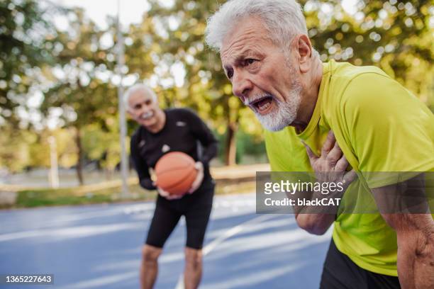 man having heart attack after sports activity - athlete torso stock pictures, royalty-free photos & images