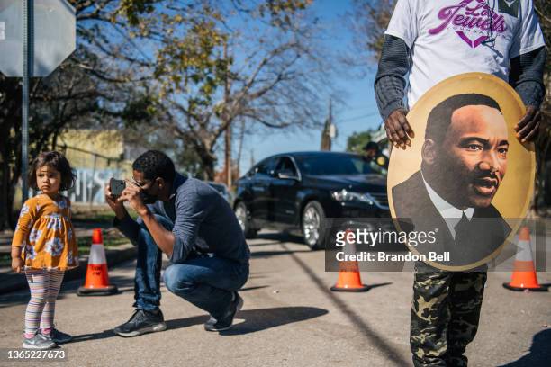 Man takes a picture of his child during the 28th Annual Martin Luther King Jr. Grande Parade on January 17, 2022 in Houston, Texas. Community...