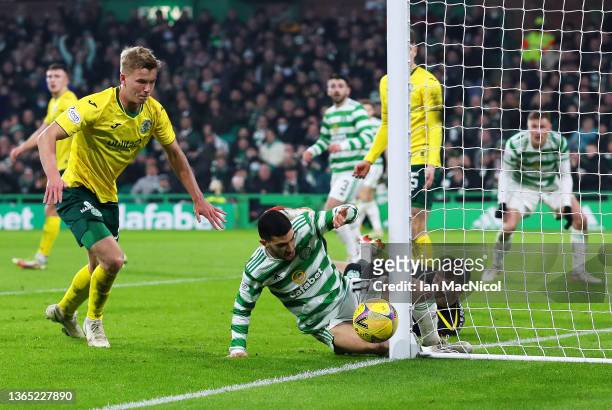 Liel Abada of Celtic slides in and hits the post as he battles for the ball with Matt Macey of Hibernian during the Cinch Scottish Premiership match...